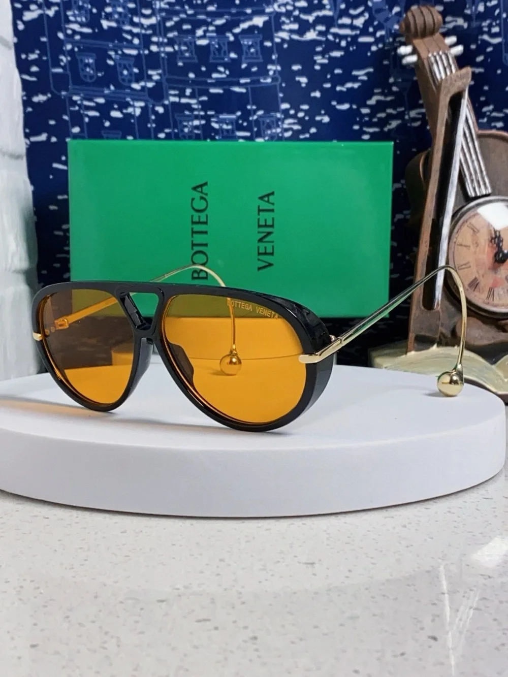 Bottega Veneta Black Frame Sunglasses with Amber Lenses and Gold Temples